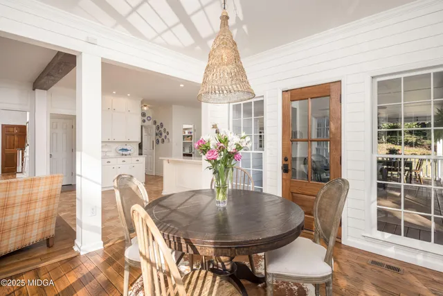 a bathroom with a sink and mirror with toilet