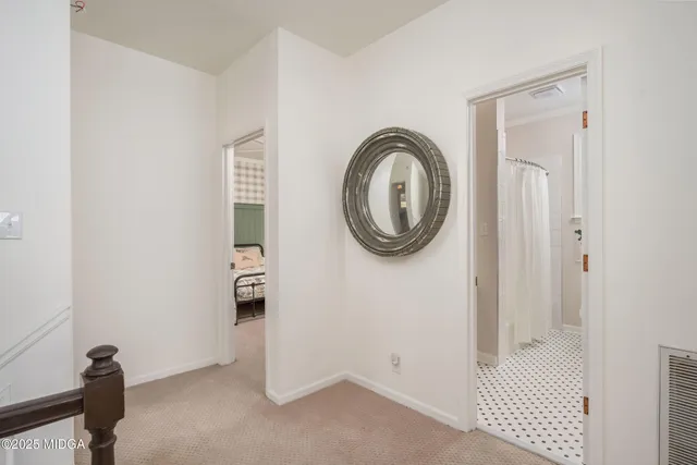 a bedroom with a bed lamp and a window