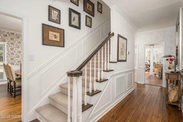a view of entryway and hall with wooden floor