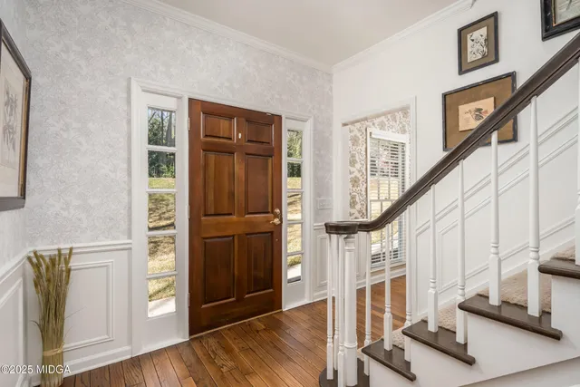 a view of an entryway with wooden floor and door