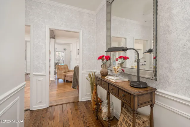 a view of a dining room with furniture and wooden floor