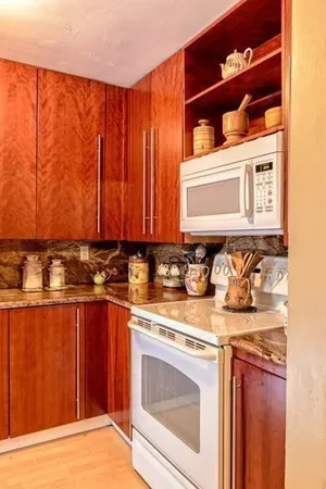 a view of a kitchen with a sink and cabinets