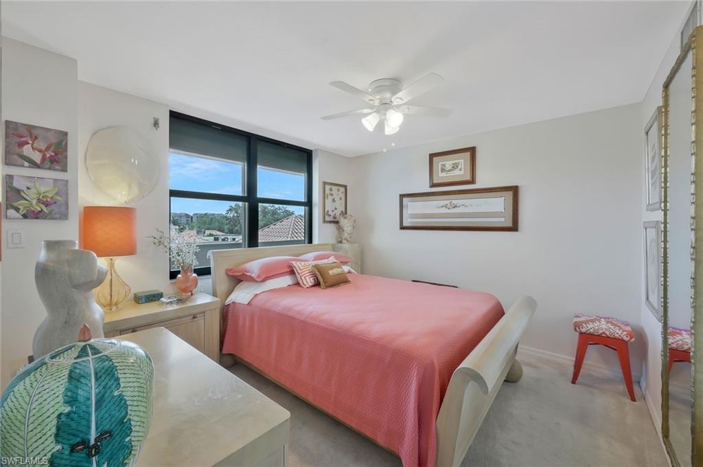 6573 Marissa Loop, Unit 303 Naples, FL 34108 - Photo 14 of 31 a bedroom with a bed couch and window