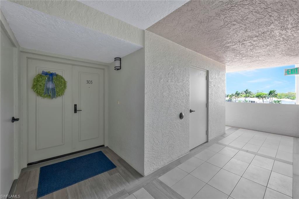 6573 Marissa Loop, Unit 303 Naples, FL 34108 - Photo 3 of 31 a view of a room with wooden floor