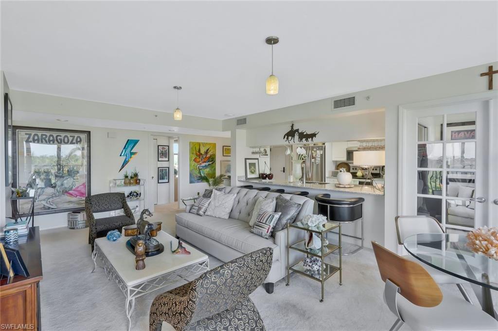 6573 Marissa Loop, Unit 303 Naples, FL 34108 - Photo 5 of 31 a living room with furniture and a large window