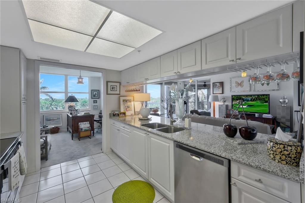 6573 Marissa Loop, Unit 303 Naples, FL 34108 - Photo 30 of 31 a kitchen with sink cabinets and outdoor living space