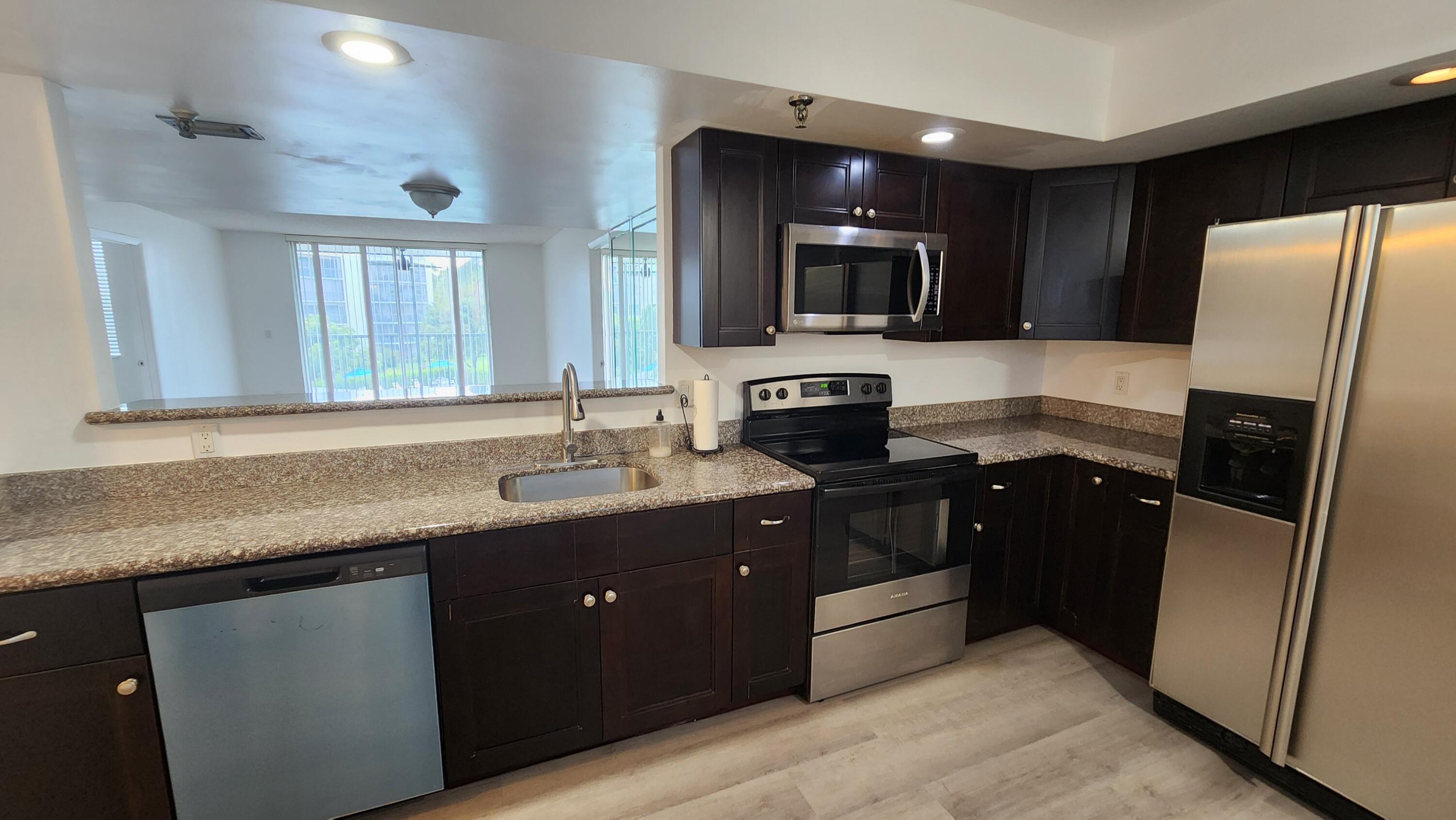 6500 Northwest 2nd Avenue, Unit 311 Boca Raton, FL 33487 - Photo 17 of 43 Open kitchen to livingroom