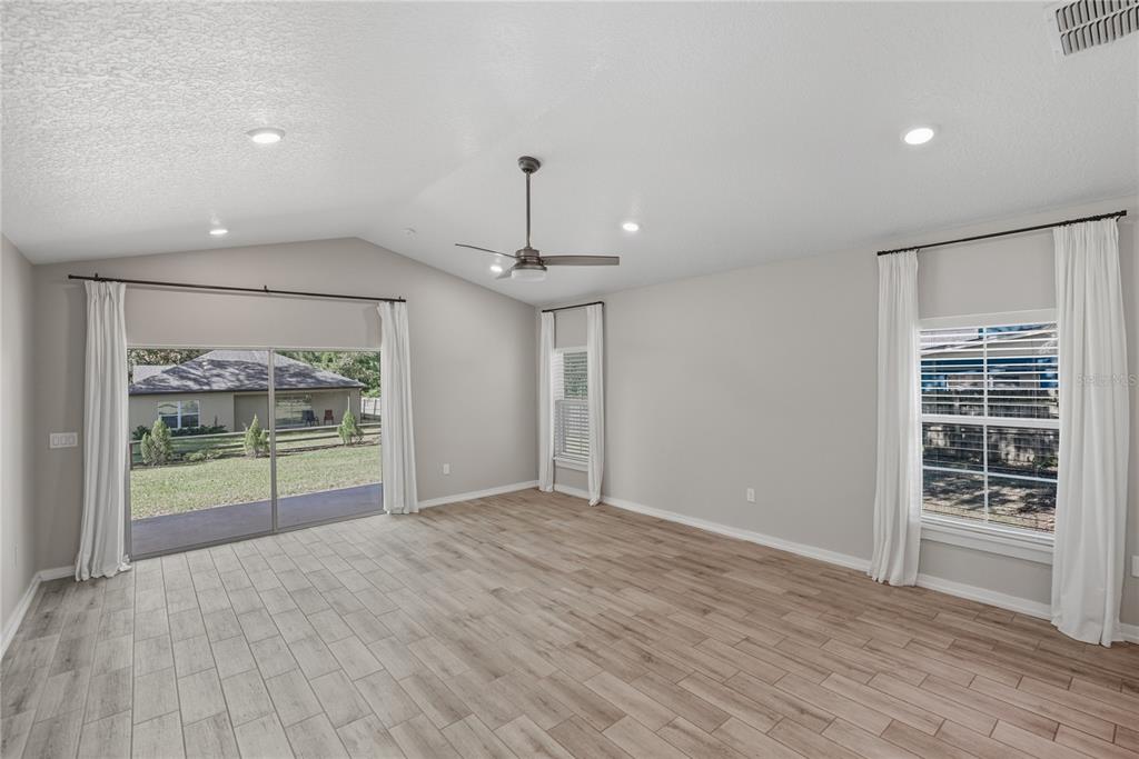 13907 9th Street Dade City, FL 33525 - Photo 16 of 43 a view of a room with wooden floor and large windows