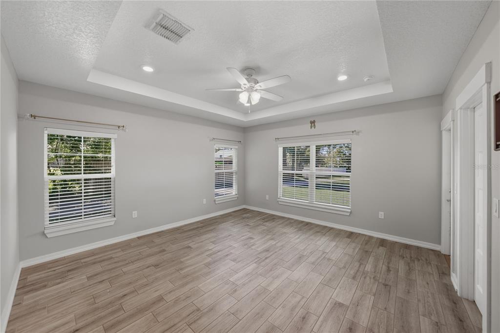 13907 9th Street Dade City, FL 33525 - Photo 19 of 43 a view of an empty room with wooden floor and a window