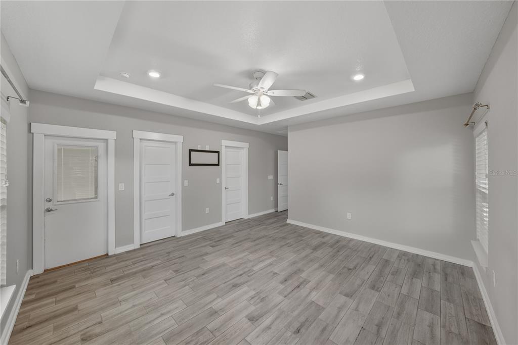 13907 9th Street Dade City, FL 33525 - Photo 21 of 43 wooden floor in an empty room with a window