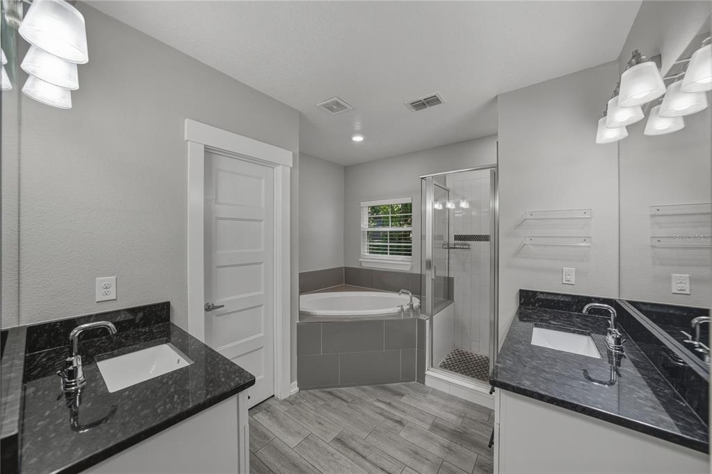 13907 9th Street Dade City, FL 33525 - Photo 22 of 43 a bathroom with a sink a toilet and shower