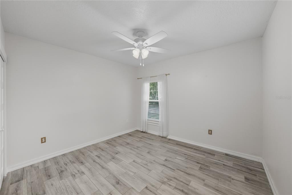 13907 9th Street Dade City, FL 33525 - Photo 27 of 43 wooden floor in an empty room