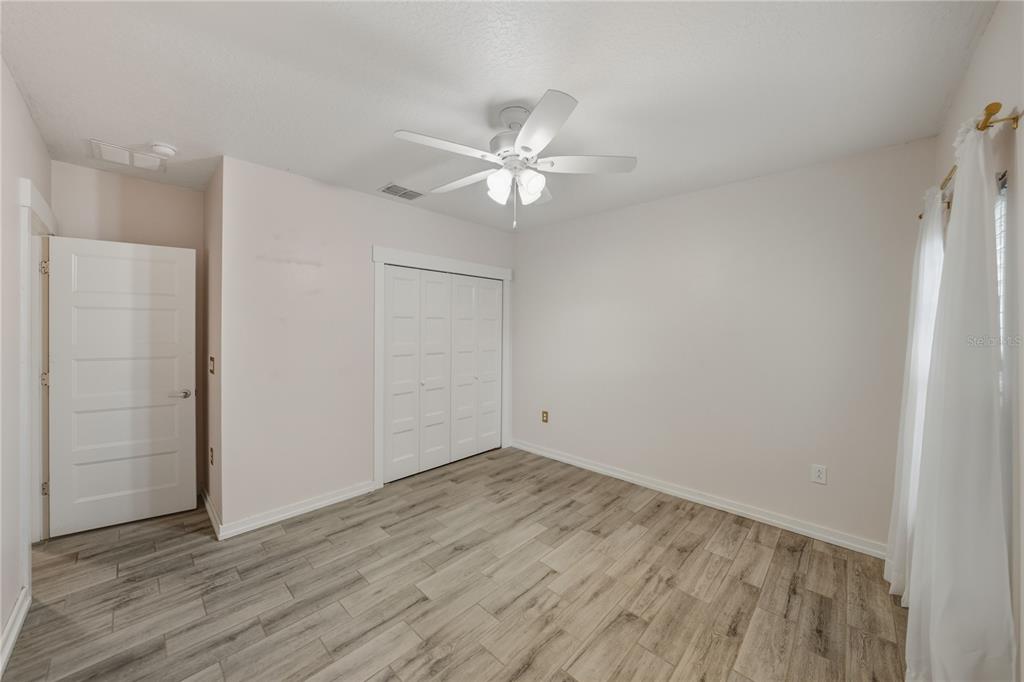13907 9th Street Dade City, FL 33525 - Photo 28 of 43 wooden floor in an empty room
