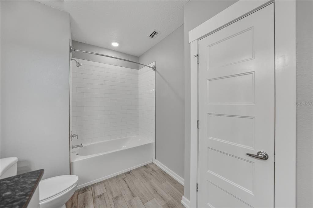 13907 9th Street Dade City, FL 33525 - Photo 31 of 43 a bathroom with a shower and a toilet