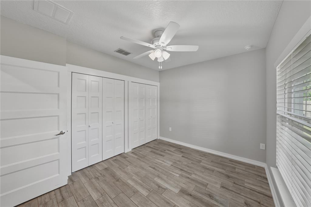 13907 9th Street Dade City, FL 33525 - Photo 33 of 43 wooden floor in an empty room with a window