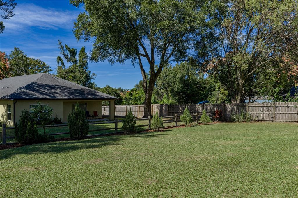 13907 9th Street Dade City, FL 33525 - Photo 42 of 43 a view of a trees in front of a house