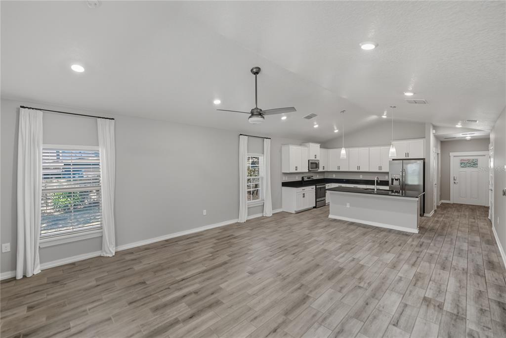 13907 9th Street Dade City, FL 33525 - Photo 8 of 43 a view of kitchen with kitchen island stainless steel appliances sink and cabinets