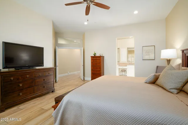 a bedroom with a bed and a flat screen tv