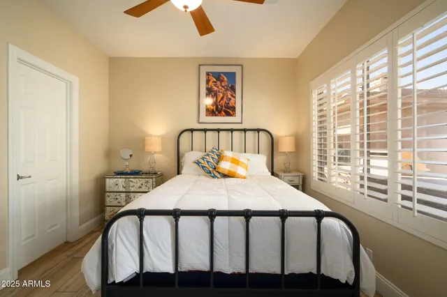 a bedroom with a bed and a large window