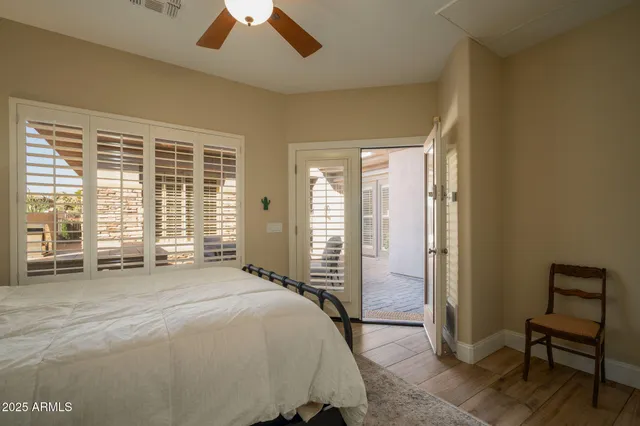 a spacious bedroom with a bed and a large window