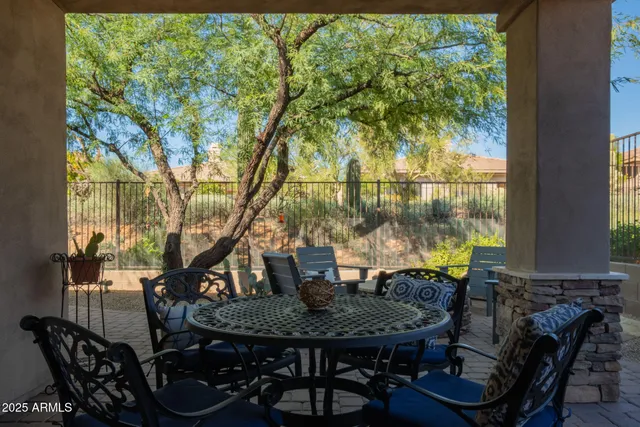 a view of a balcony dining table and chairs