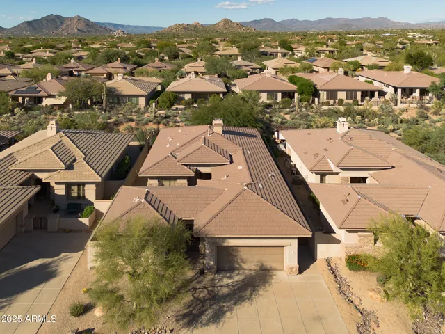 an aerial view of residential houses with outdoor space