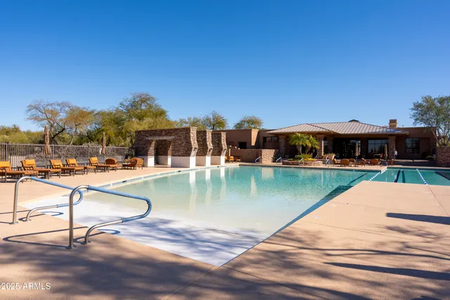 a view of a swimming pool with lounge chairs