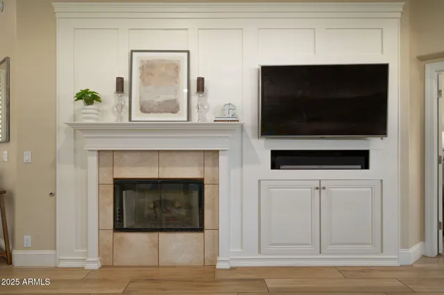 a living room with a fireplace and a flat screen tv