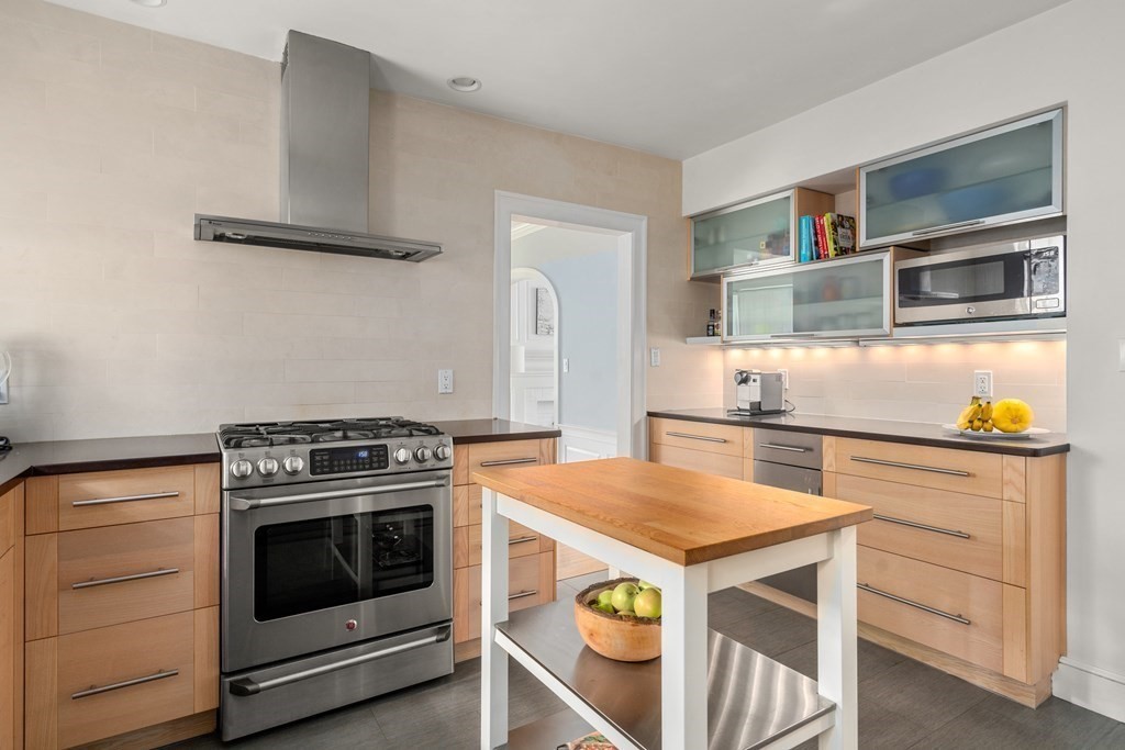 79 University Road, Unit 2 Brookline, MA 02445 - Photo 11 of 35 a kitchen with a stove and a microwave