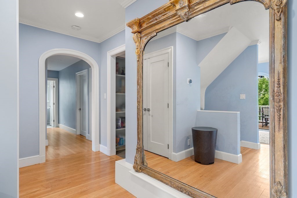 79 University Road, Unit 2 Brookline, MA 02445 - Photo 18 of 35 a view of an empty room with wooden floor and a window