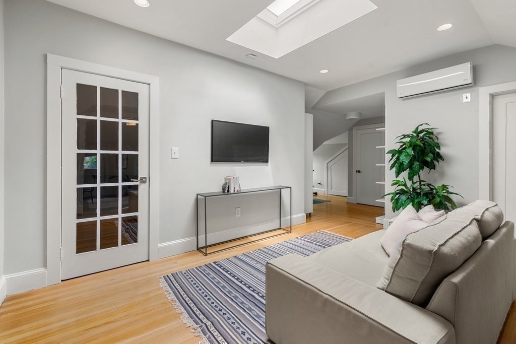 79 University Road, Unit 2 Brookline, MA 02445 - Photo 24 of 35 a living room with furniture and a flat screen tv
