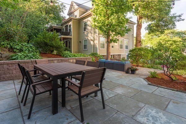 79 University Road, Unit 2 Brookline, MA 02445 - Photo 30 of 35 a view of a wooden chairs and table in the patio