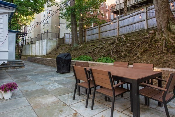 79 University Road, Unit 2 Brookline, MA 02445 - Photo 31 of 35 a backyard of a house with table and chairs