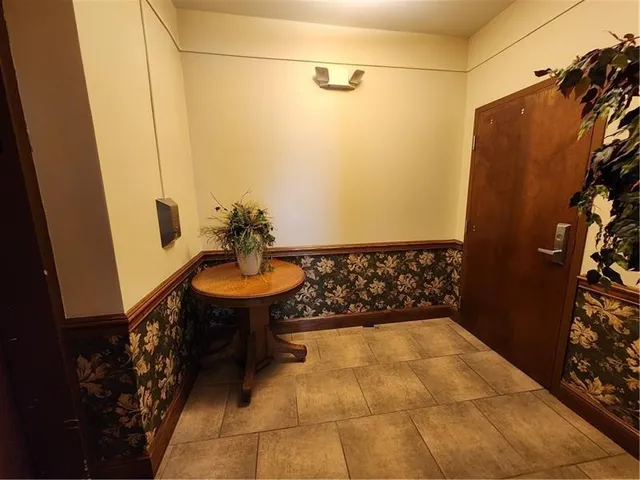 a bedroom with bed and a potted plant