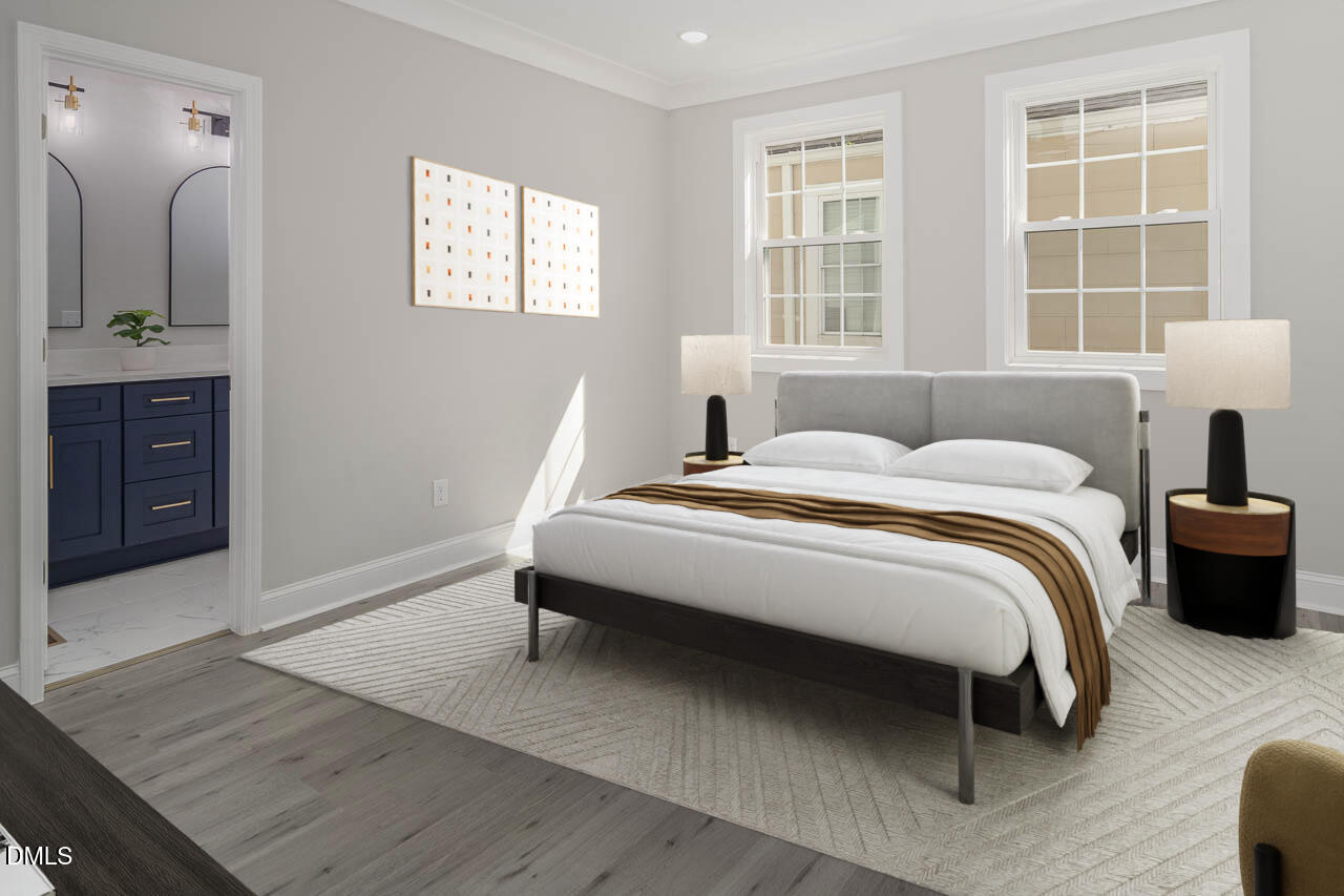 101 South Maple Street Durham, NC 27703 - Photo 11 of 27 a bedroom with a bed and wooden floor