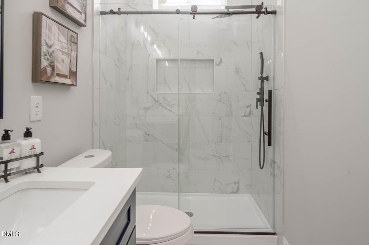 101 South Maple Street Durham, NC 27703 - Photo 24 of 27 a bathroom with a sink toilet and shower
