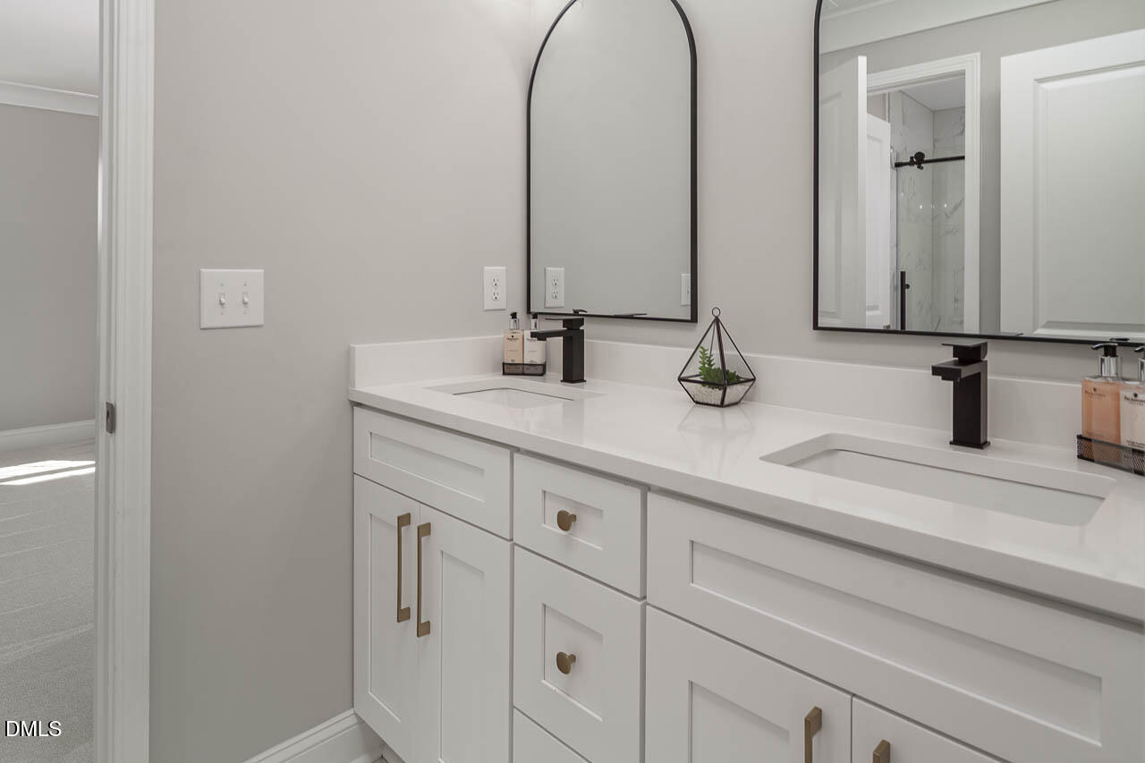 101 South Maple Street Durham, NC 27703 - Photo 25 of 27 a bathroom with a double vanity sink and a mirror