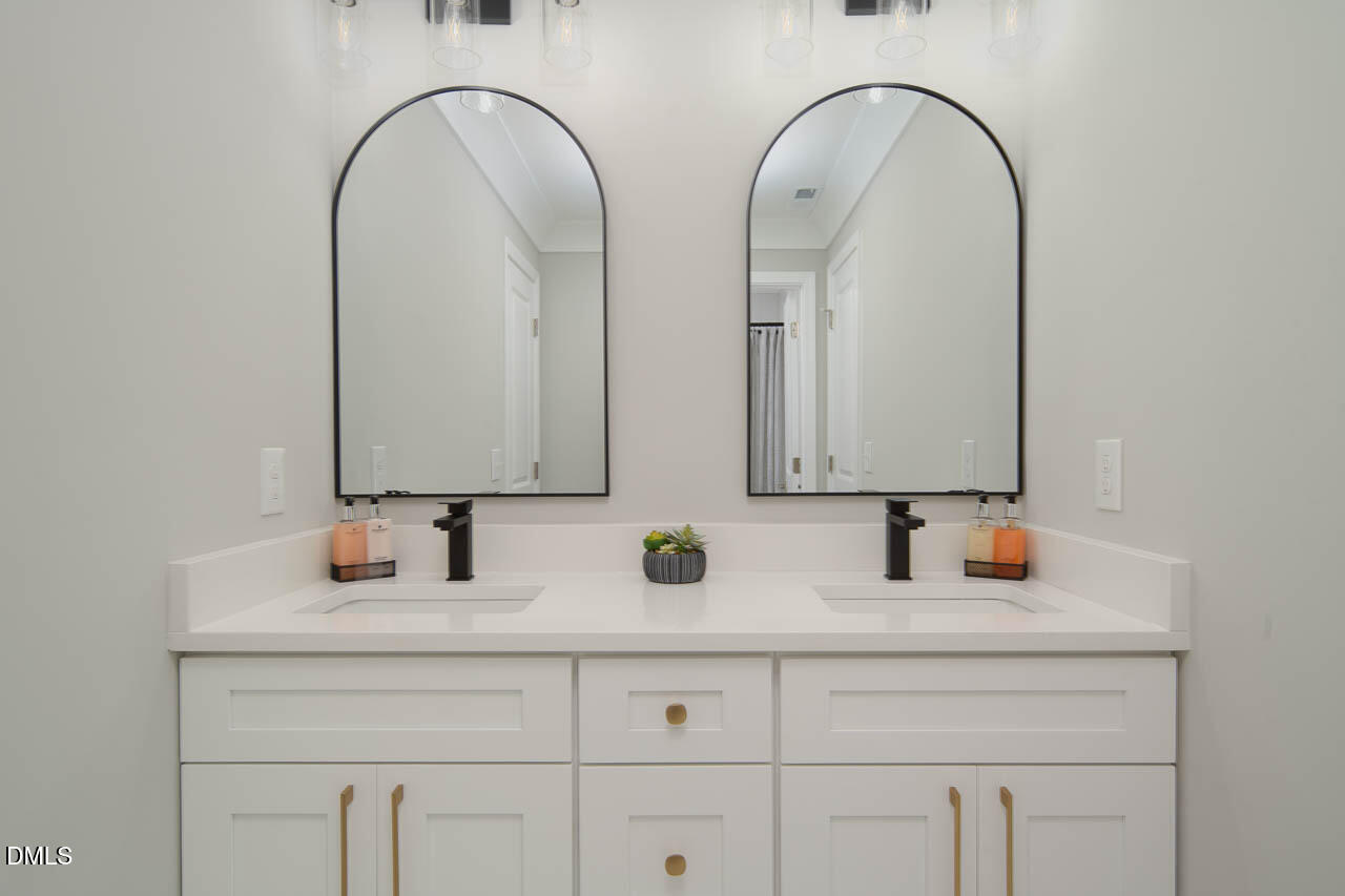 101 South Maple Street Durham, NC 27703 - Photo 26 of 27 a bathroom with a granite countertop toilet a sink and mirror