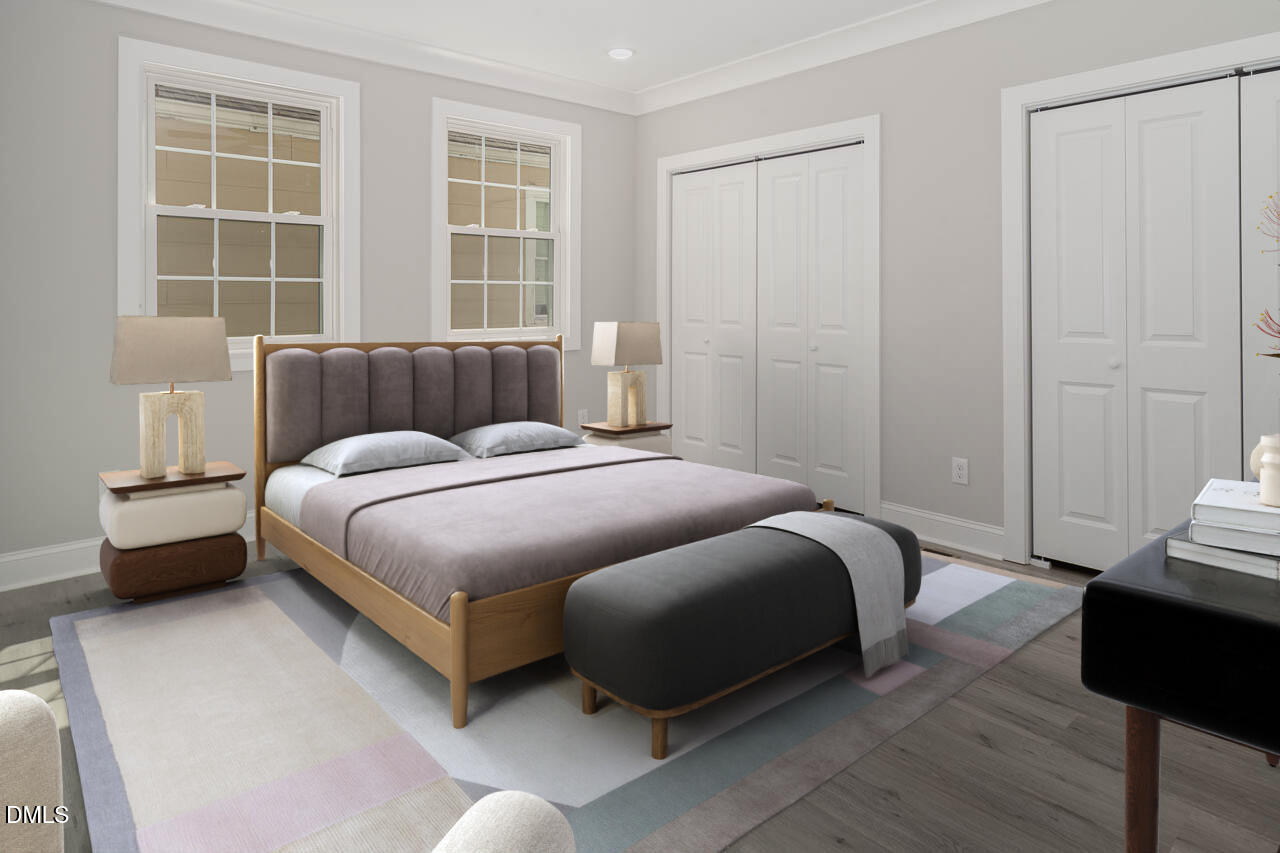 101 South Maple Street Durham, NC 27703 - Photo 10 of 27 a bedroom with a bed and wooden floor