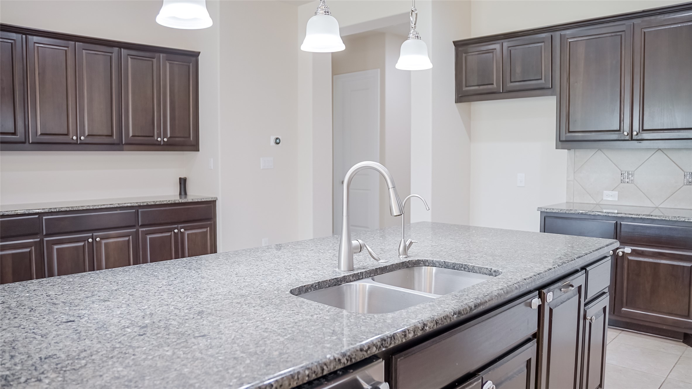 184 Fort Cobb Way Georgetown, TX 78628 - Photo 14 of 33 a kitchen with stainless steel appliances granite countertop a sink dishwasher and cabinets with wooden floor