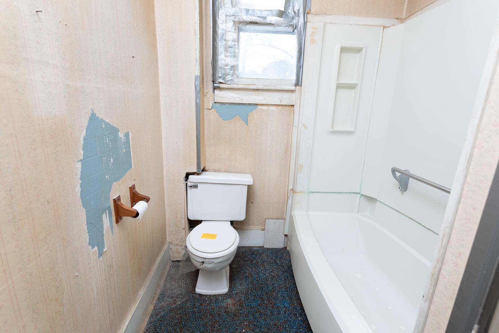 1202 Georgia Avenue Athens, TN 37303 - Photo 8 of 13 a white toilet sitting next to a bath tub