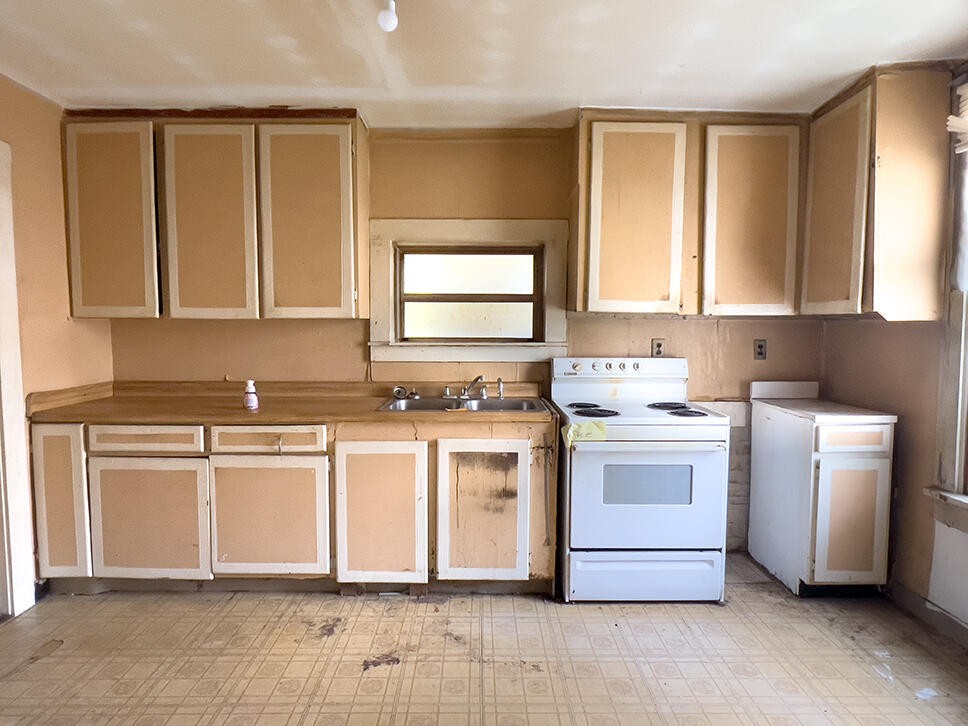 1202 Georgia Avenue Athens, TN 37303 - Photo 9 of 13 a kitchen with a stove oven and white cabinets