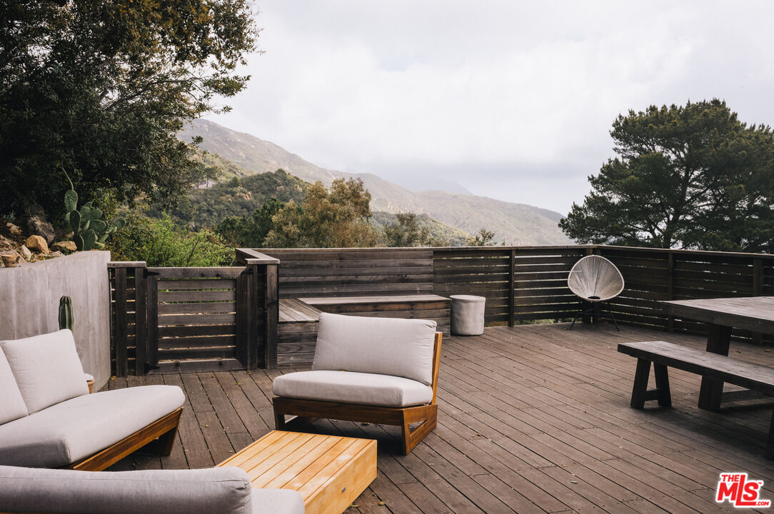 4828 Glenn Road Santa Barbara, CA 93105 - Photo 19 of 31 a roof deck with couches and wooden floor