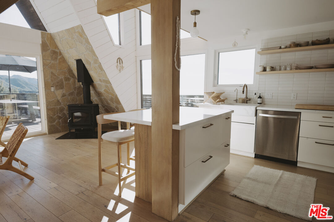 4828 Glenn Road Santa Barbara, CA 93105 - Photo 7 of 31 a kitchen with cabinets and wooden floor