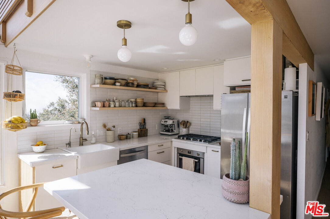 4828 Glenn Road Santa Barbara, CA 93105 - Photo 8 of 31 a kitchen with a sink stainless steel appliances and cabinets