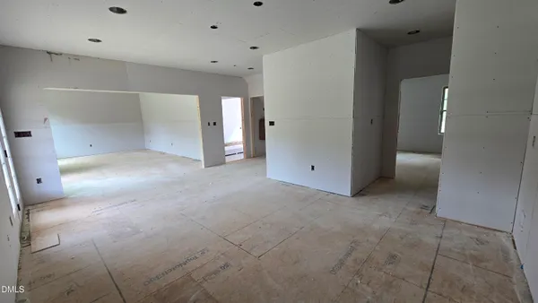 an empty room that has a mirror in it