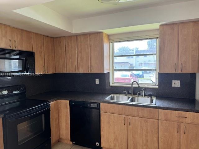 7350 Southwest 82nd Street, Unit C125 Miami, FL 33143 - Photo 1 of 12 a kitchen with granite countertop a sink stove and microwave