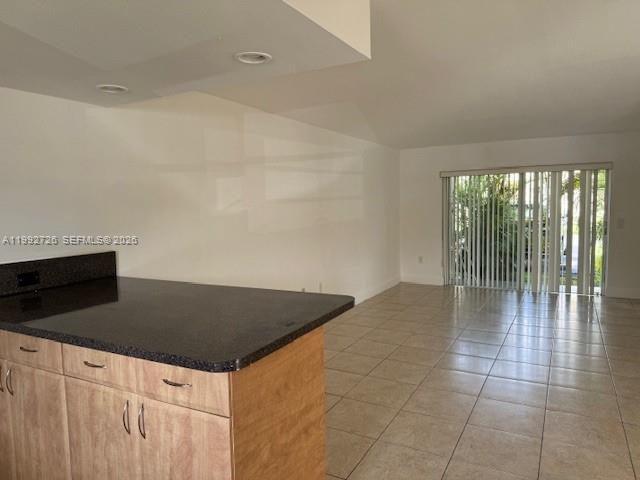 7350 Southwest 82nd Street, Unit C125 Miami, FL 33143 - Photo 10 of 12 a kitchen with granite countertop a stove a sink and a granite counter tops