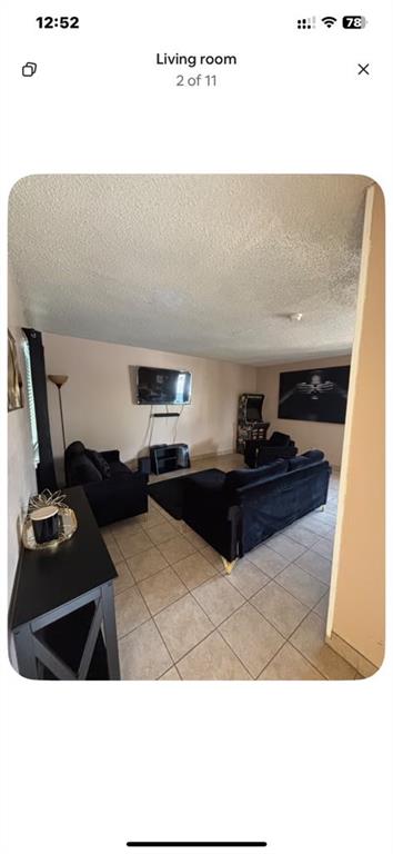 5615 Harvest Hill Road, Unit 2015 Dallas, TX 75230 - Photo 2 of 9 a living room with furniture and a table