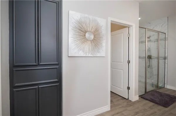 a view of a hallway with wooden floor